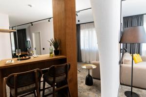 a hotel room with a desk and a bed at MM Boutique Hotel in Burgas