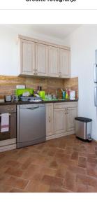 a kitchen with white cabinets and a tile floor at Skadar lake house Bobija in Podgorica