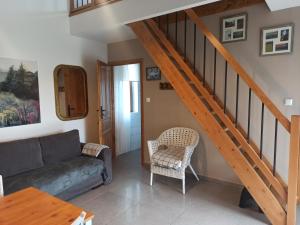 a living room with a couch and a staircase at Piękne Zielone in Zator