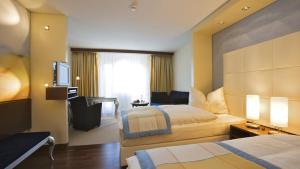 A bed or beds in a room at Revier Hotel Säntispark