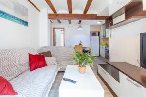 a living room with a white couch and red pillows at apartamento con terraza in Valencia