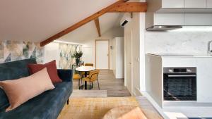 a living room with a blue couch and a table at HM - Home Feeling Studio Campanhã in Porto