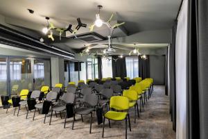 a conference room with yellow and black chairs at MM Boutique Hotel in Burgas