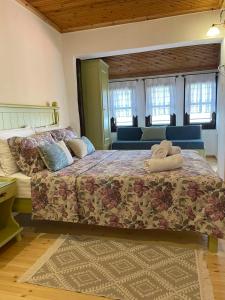 a bedroom with a large bed with pillows on it at To Patriko Mas Guesthouse-2 in Palaios Panteleimonas