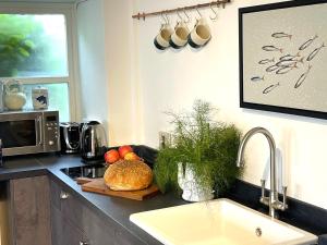 a kitchen with a counter top with a sink and a counter sidx sidx at Charming Studio in Heart of Vibrant St Just, West Cornwall in St Just