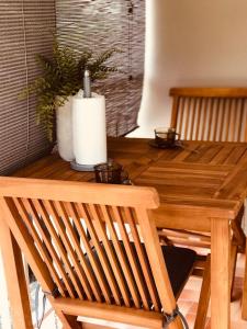 a wooden table with a plant on top of it at La Villa Didine in Sainte-Luce