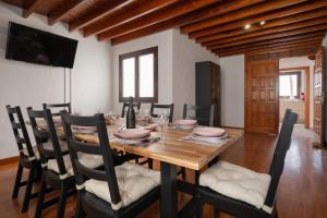 a dining room with a wooden table and chairs at Santa Rosa La Peñita (Puerto del Carmen) in Puerto del Carmen