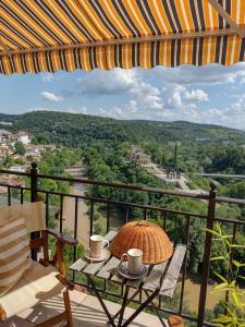 a table and chairs on a balcony with a view at Art Studio Turnovo in Veliko Tŭrnovo