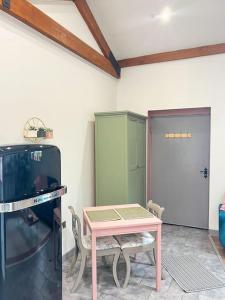 a room with a table and a tv and a door at Aplanty Nest amidst the Orchard 