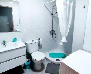 a white bathroom with a toilet and a shower at Room in Lodge - Big Room Tenerife Sur Private Bathroom Wifi in Arona