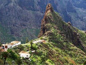 a mountain with a house on top of it at Big Room Tenerife Sur Private Bathroom Wifi in Arona +2 photos