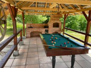 a pool table in a pavilion with a fireplace at Cabana Transilvania in Beliş