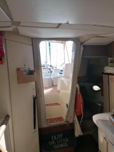 an open door of a small boat with a room at Dormir sur un yacht insolite in La Rochelle