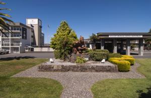 a statue of a man sitting in a park at Copthorne Hotel Rotorua in Rotorua