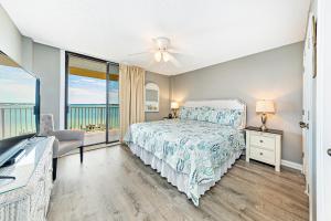 a bedroom with a bed and a view of the ocean at Compass Point 303 in Gulf Shores