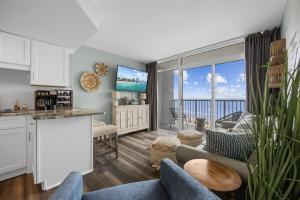 a kitchen and living room with a view of the ocean at Direct OCEANFRONT- King Bedroom- AMAZING VIEWS/Pools/Hot Tubs/Beach Access/Golf in Myrtle Beach