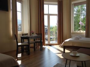 a room with a bed and a table and a window at The Lion Rooms in Ustroń +33 photos