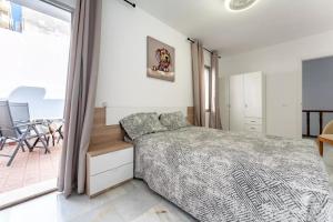 a bedroom with a bed and a large window at Casa capitán in Fuengirola