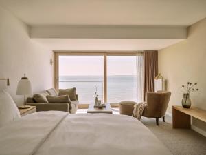 a hotel room with a large bed and a large window at 1884 Norderney in Norderney
