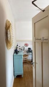 a hallway with a blue cabinet in a room at Bubbles & Bed in Bilthoven