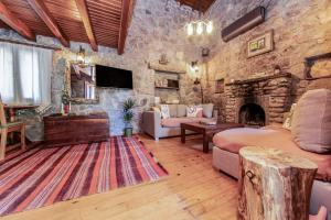 a living room with a stone wall at Chic Villa w Fireplace 3 min to Beach in Bodrum in Bitez