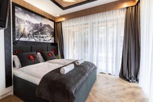 Łóżko lub łóżka w pokoju w obiekcie Modrzejewska Residence Zakopane