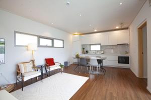 a kitchen and living room with a table and chairs at Namhae Bay 591 in Namhae