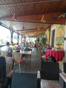 a group of people sitting at tables in a restaurant at Gostilna in apartmaji Zlati lev - Maribor in Maribor