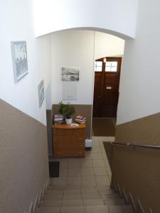 a hallway with a staircase with a door and a dresser at The Lion Rooms in Ustroń