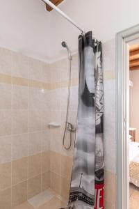 a shower in a bathroom with a shower curtain at Michalios Luxury Apartments in Koufonisia