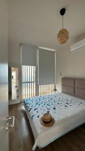 a bedroom with a large bed with a hat on it at Le bellevue apartment in Llogara