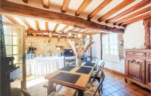 a dining room with a table and a kitchen at Pet Friendly Home In Touffreville With Kitchen in Touffreville