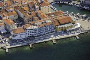 an aerial view of a city with buildings and water at Hotel Piran in Piran