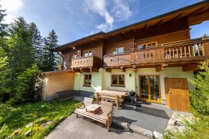a log house with a deck and a patio at Appartement Juri Hochkrimml in Nothdorf