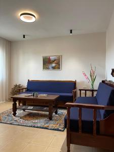 a living room with a blue couch and a coffee table at Leo’s apartment in Shkodër