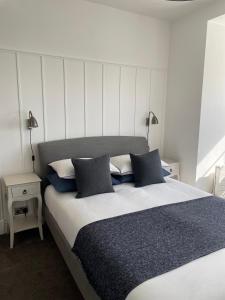 a bedroom with a large bed with two pillows at Falmouth Bay in Falmouth