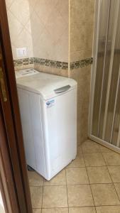 a small white washer and dryer in a bathroom at CIVICO 352 APARTMENT in Scafati