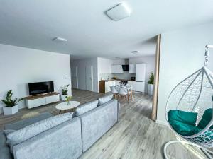 a living room with a couch and a table at LAWIS Apartments in Poprad