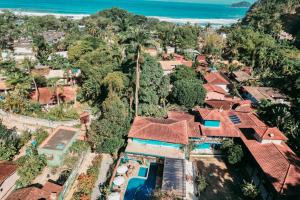 an aerial view of a village with houses and the ocean at Pousada Villa Atlântica in Camburi +66 photos