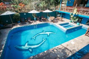 a swimming pool with a shark painted on it at Pousada Villa Atlântica in Camburi
