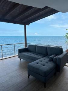 a couch sitting on a deck near the ocean at Trabzon 4 storey Villa-House by the sea - Denize sıfır 4 katlı müstakil Villa - Ev in Trabzon