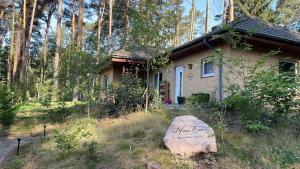 una pequeña casa con una roca delante de ella en Haus Eva, en Groß Gusborn 4 fotos más