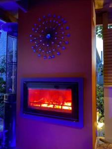 a fireplace in a living room with a red fire at Greenfields Spa with private hottub New listing in Malvern Link