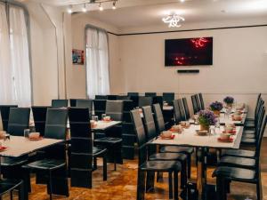 a dining room with tables and chairs in a room at Hotel Luxia in Paris