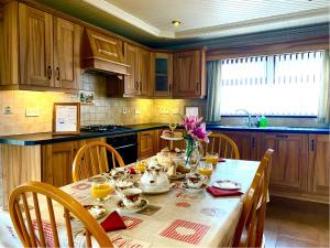 a kitchen with a table with a tea set at Glenview Cottage in Keady