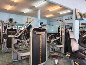 a gym with lots of treadmills and machines at SK Hometel Samui Airport in Bang Rak Beach