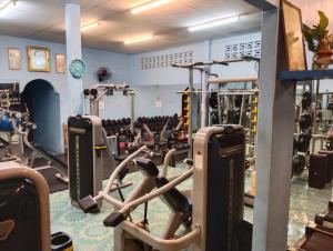 a gym with lots of cardio equipment in a room at SK Hometel Samui Airport in Bang Rak Beach