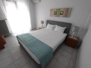 Postel nebo postele na pokoji v ubytování Ioli Apartments + 23 fotografií