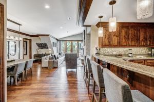 a kitchen with a bar with chairs and a living room at Ritz 2Br R614 in Vail