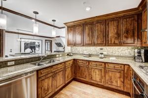 a kitchen with wooden cabinets and a sink at Ritz 2Br R614 in Vail